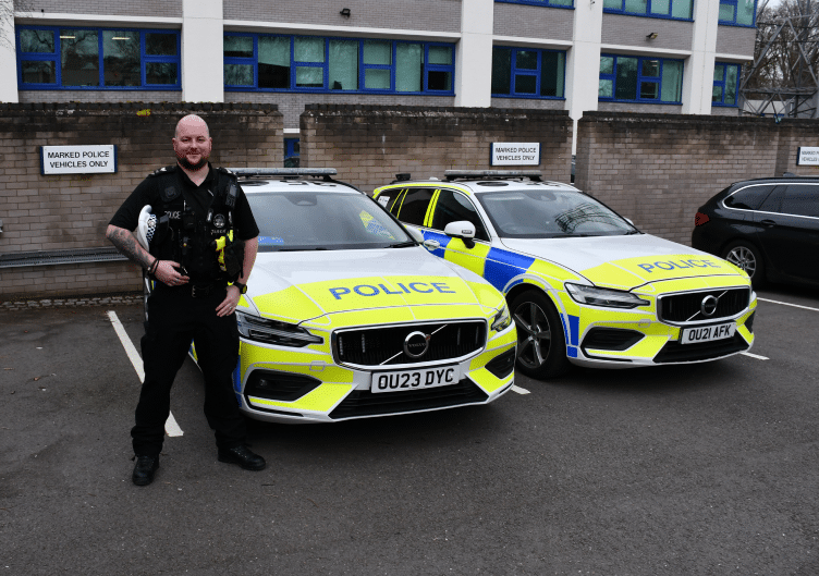 PC Jamie Cooper with Police cars