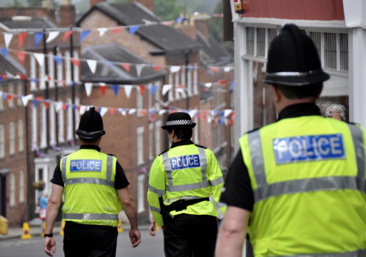 Three police officers in uniform and high vis jackets