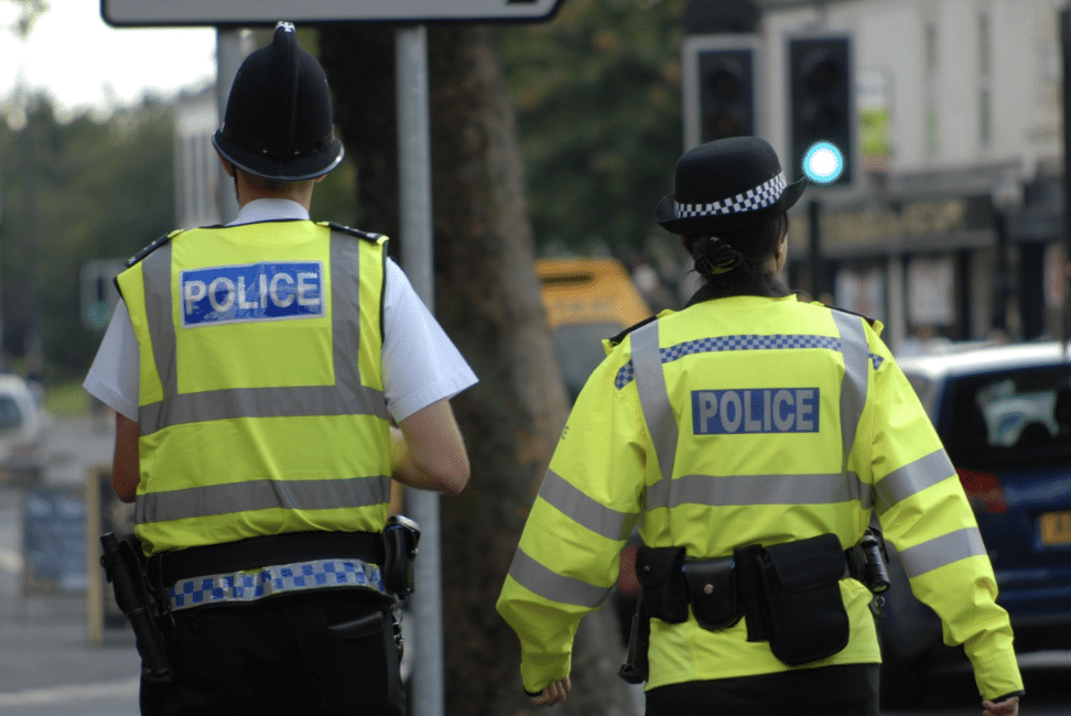 Rear view of patrolling police officers.
